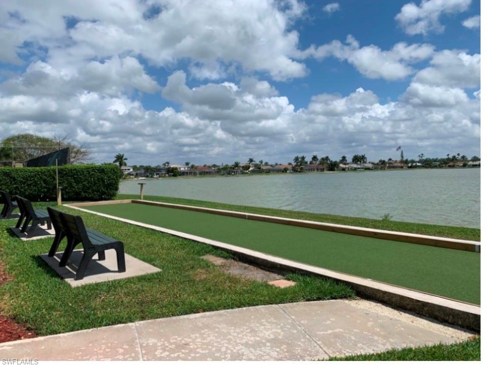 7791 Esmeralda Way, Unit L203 Naples, FL 34109 - Photo 15 of 23 a view of a lake with a big yard