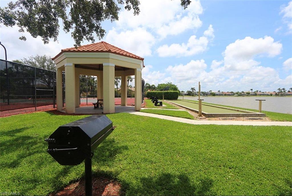 7791 Esmeralda Way, Unit L203 Naples, FL 34109 - Photo 21 of 23 a view of a house with swimming pool and porch with furniture