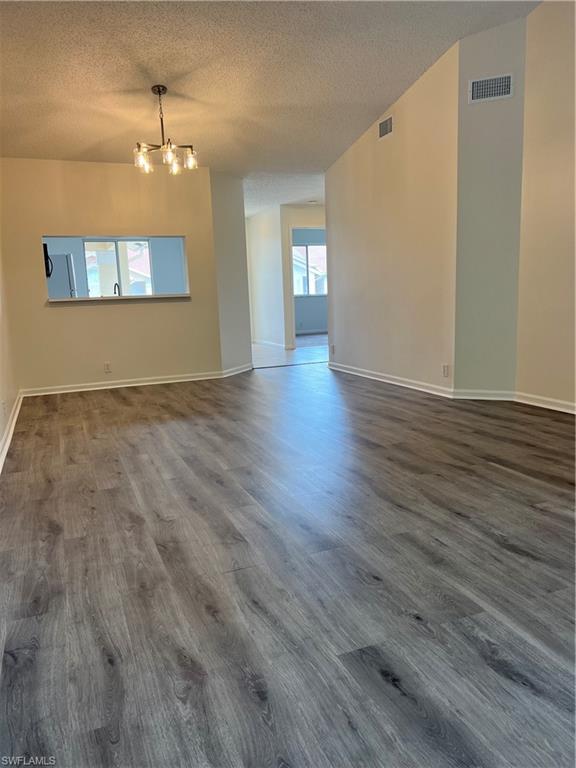 7791 Esmeralda Way, Unit L203 Naples, FL 34109 - Photo 3 of 23 a view of an empty room with wooden floor and a window