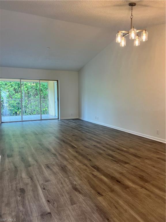 7791 Esmeralda Way, Unit L203 Naples, FL 34109 - Photo 4 of 23 a view of an empty room with wooden floor and a window