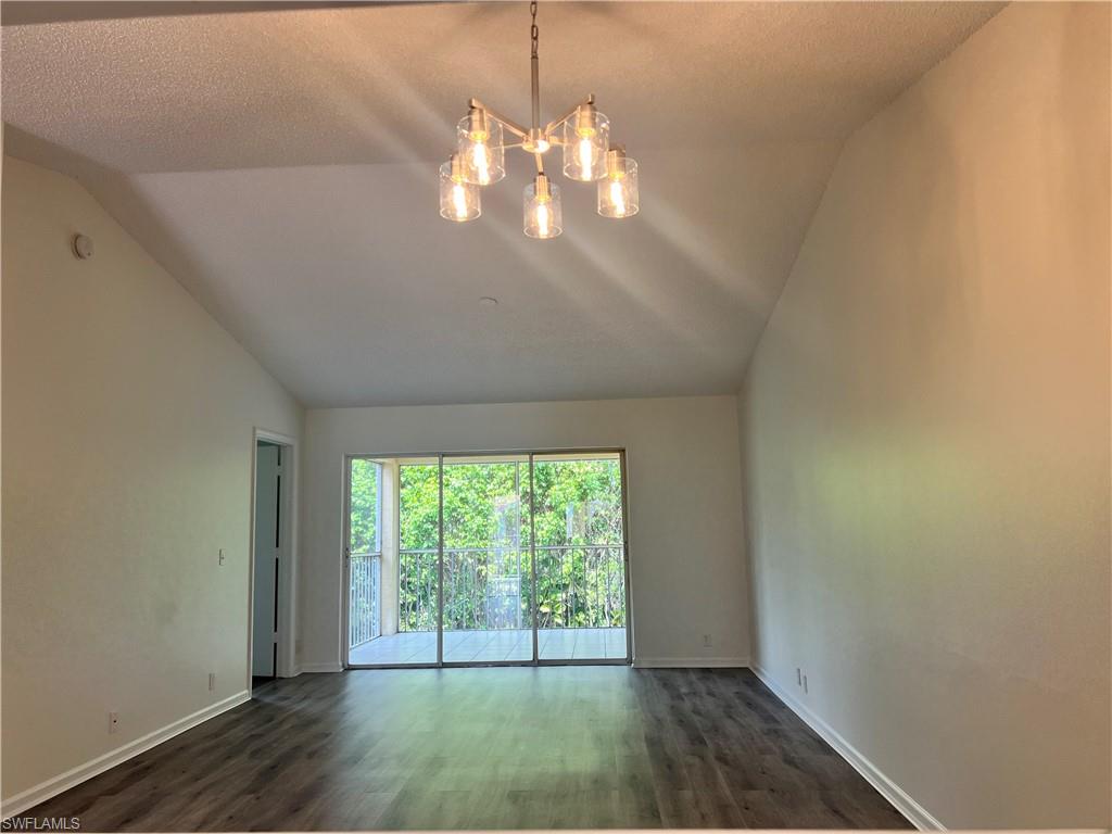 7791 Esmeralda Way, Unit L203 Naples, FL 34109 - Photo 9 of 23 a view of an empty room with wooden floor and a window