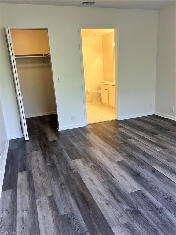 7791 Esmeralda Way, Unit L203 Naples, FL 34109 - Photo 10 of 23 a view of an empty room with wooden floor and a window