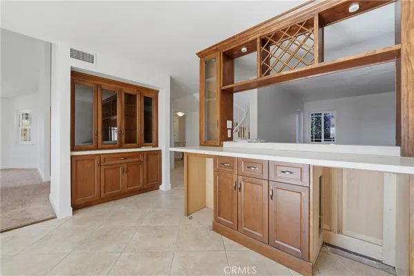 a kitchen with a sink window and cabinets