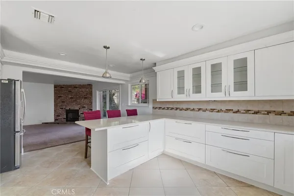 an empty room with wooden floor and a ceiling fan