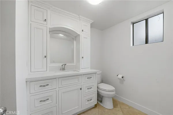 a bathroom with a granite countertop sink a toilet and bathtub