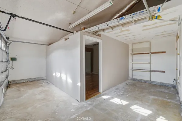 an empty room with a window and a ceiling fan