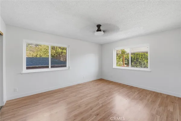 a view of house with backyard and glass windows