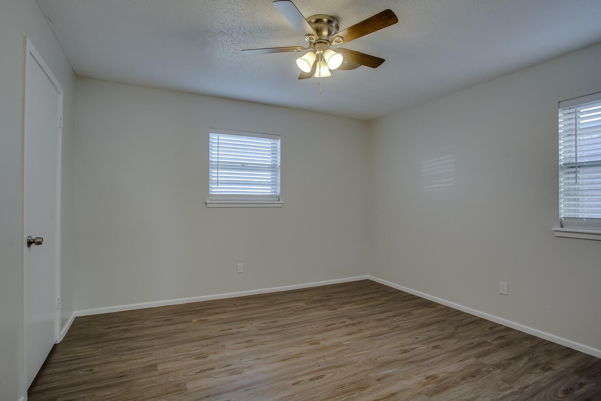 5419 46th Street Lubbock, TX 79414 - Photo 12 of 14 a view of empty room with wooden floor and fan