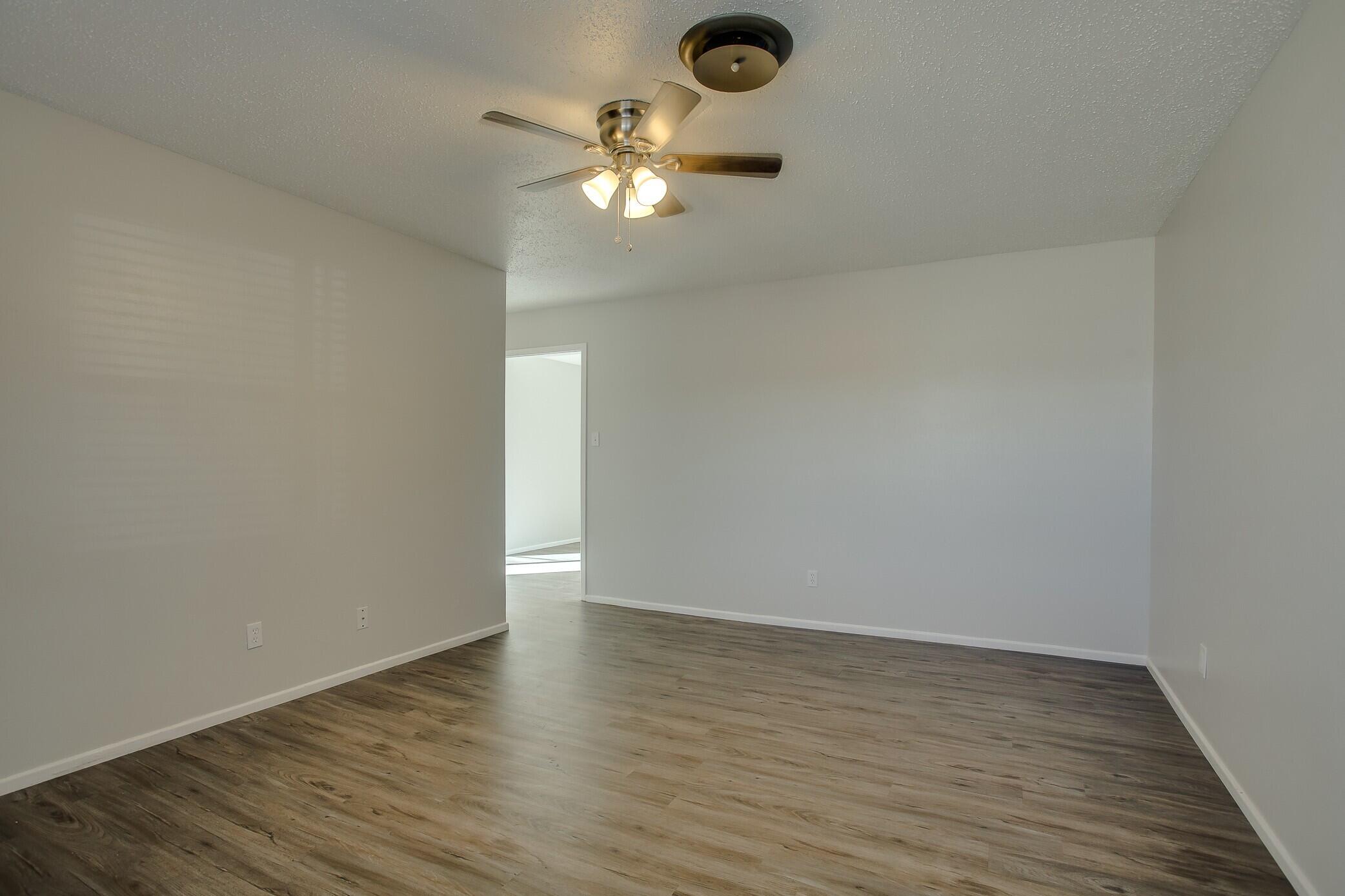 5419 46th Street Lubbock, TX 79414 - Photo 3 of 14 a view of an empty room with wooden floor