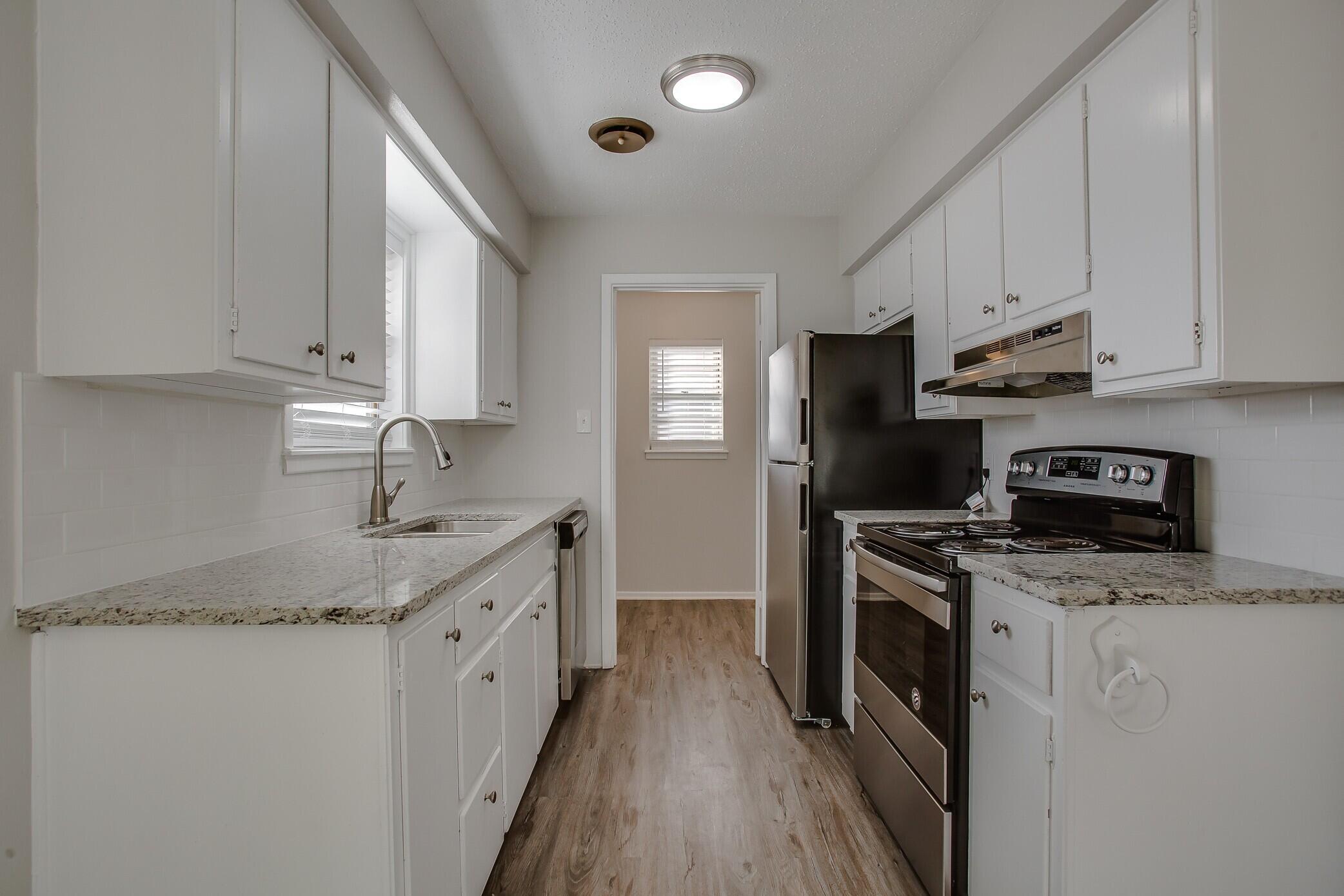 5419 46th Street Lubbock, TX 79414 - Photo 5 of 14 a kitchen with stainless steel appliances granite countertop a sink stove and refrigerator