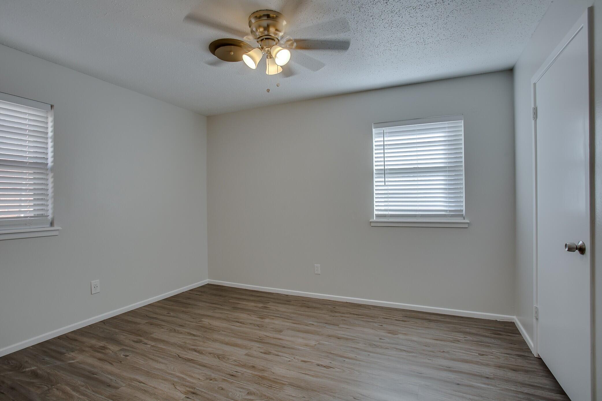 5419 46th Street Lubbock, TX 79414 - Photo 9 of 14 wooden floor in an empty room with a window
