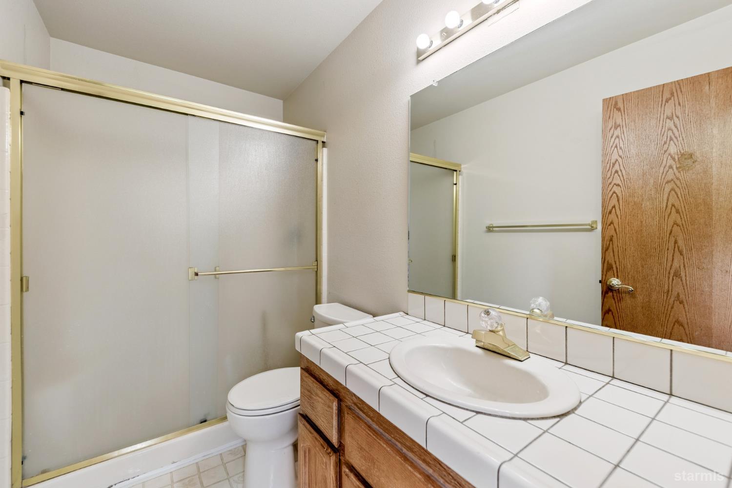 2699 Elwood Avenue South Lake Tahoe, CA 96150 - Photo 15 of 27 a bathroom with a granite countertop sink toilet and shower