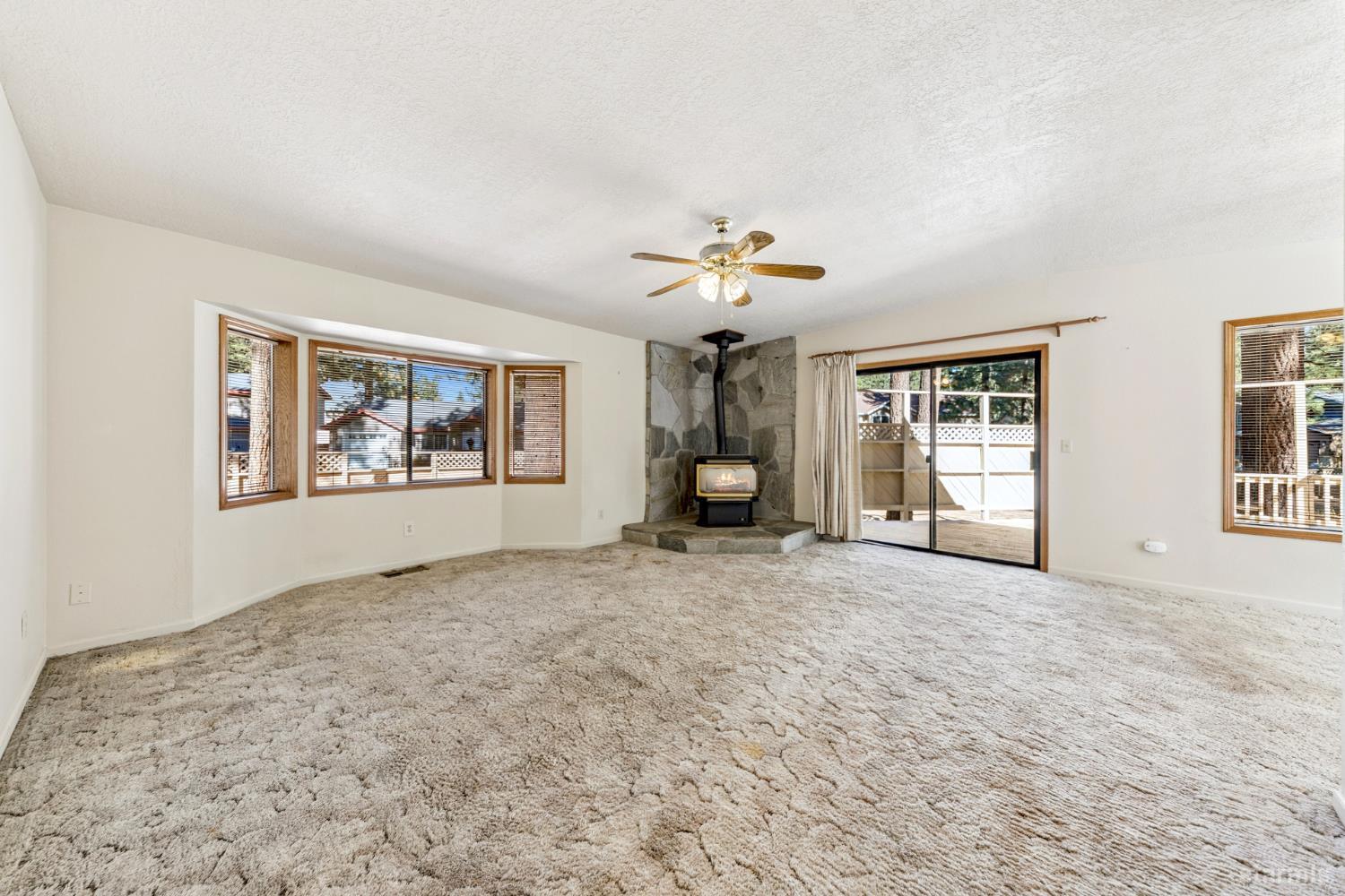 2699 Elwood Avenue South Lake Tahoe, CA 96150 - Photo 2 of 27 a view of an empty room with a window and a kitchen