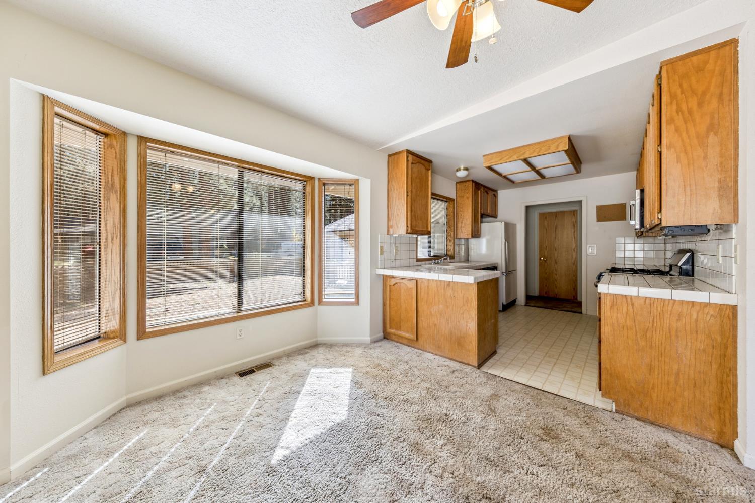 2699 Elwood Avenue South Lake Tahoe, CA 96150 - Photo 5 of 27 a view of a kitchen with a sink dishwasher large window with kitchen view