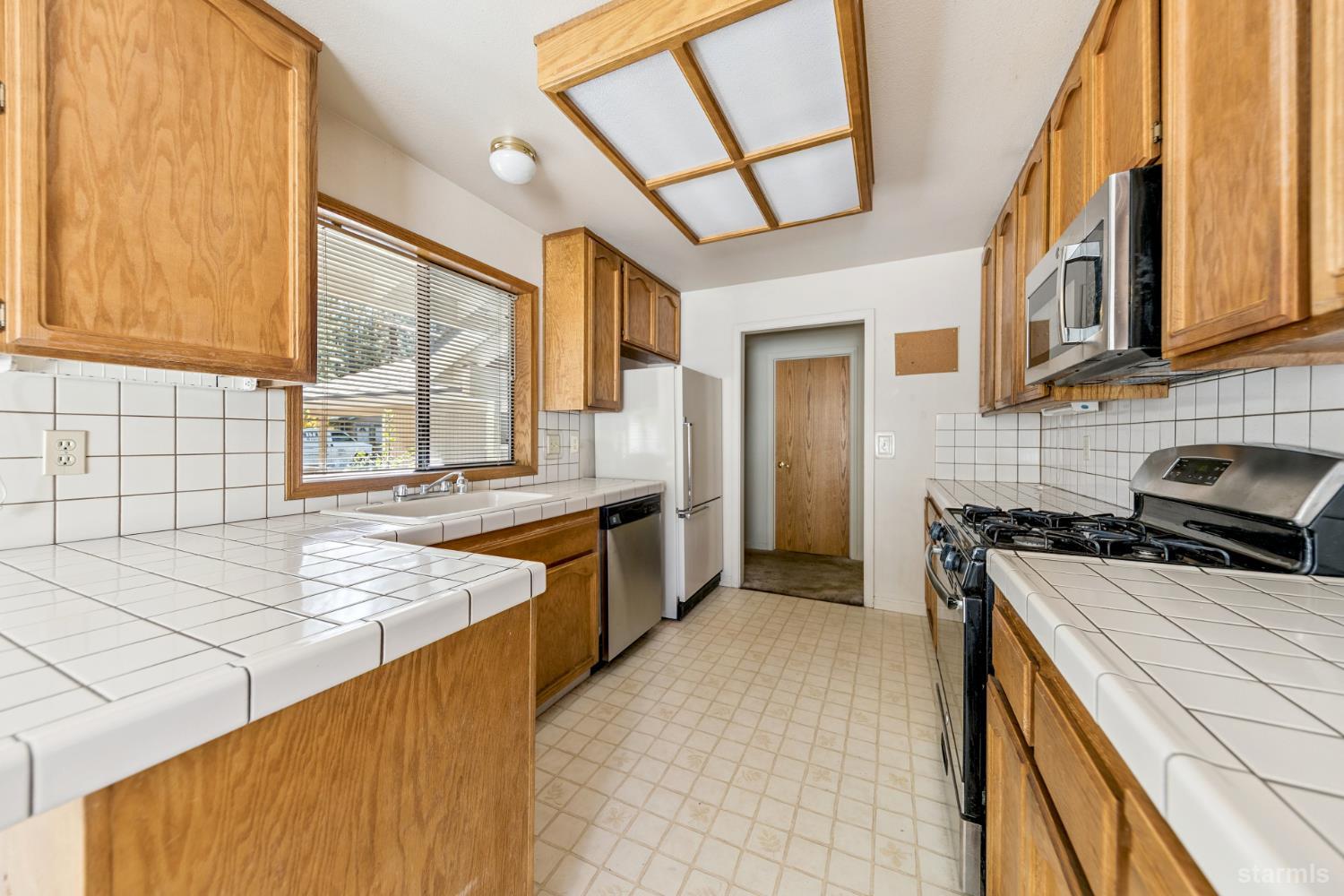 2699 Elwood Avenue South Lake Tahoe, CA 96150 - Photo 6 of 27 a kitchen with stainless steel appliances granite countertop a stove a sink and a refrigerator