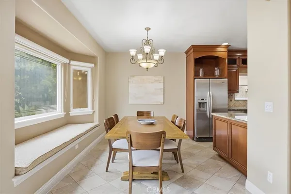 a kitchen with stainless steel appliances granite countertop a refrigerator and a stove