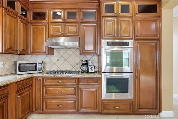 a spacious bedroom with a bed and a flat screen tv