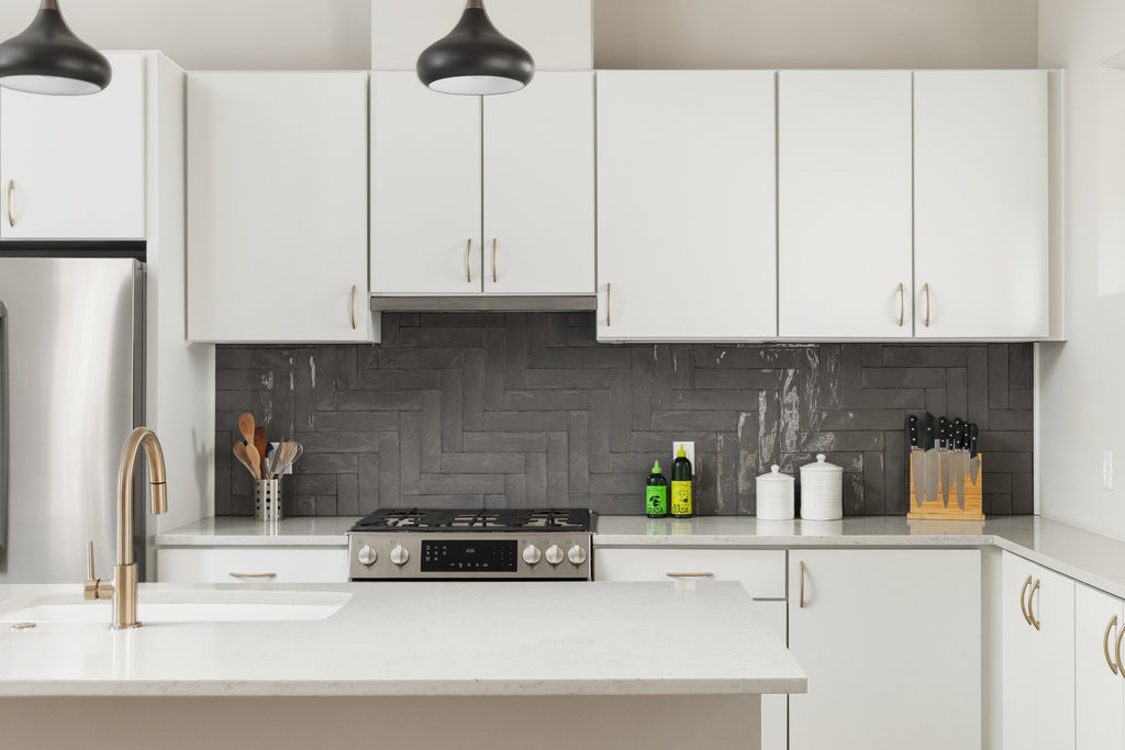 2300 Enfield Road, Unit 303 Austin, TX 78703 - Photo 17 of 38 a kitchen with a white cabinets and a counter top space