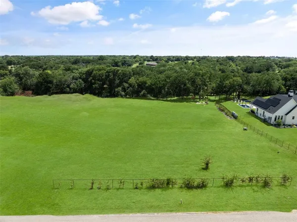 a view of a field with an ocean