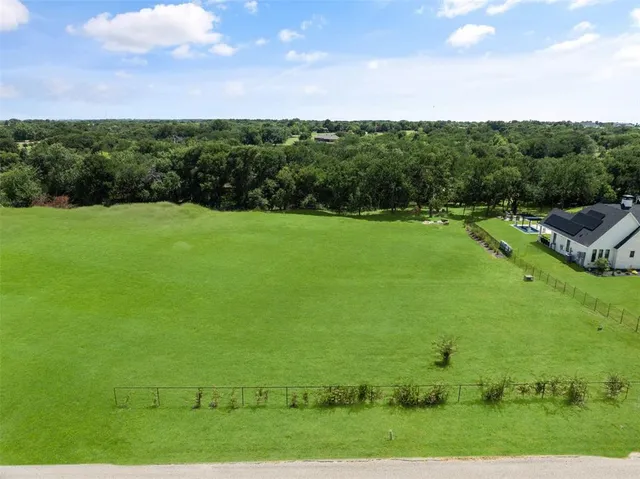a view of a field with an ocean