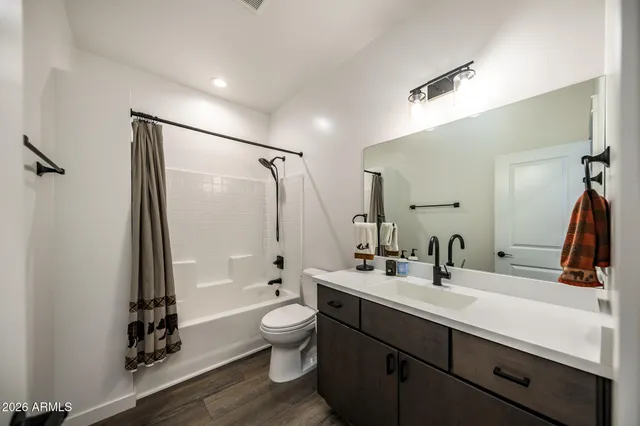 a bathroom with a double vanity sink toilet and shower