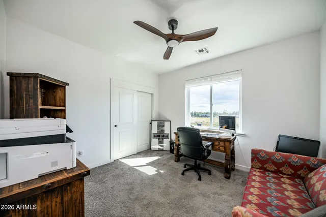 a bedroom with bed couch and window