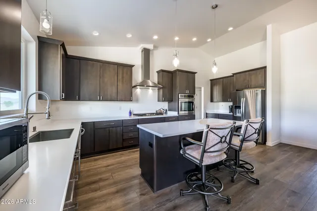 a kitchen with a sink a counter top space stainless steel appliances and cabinets