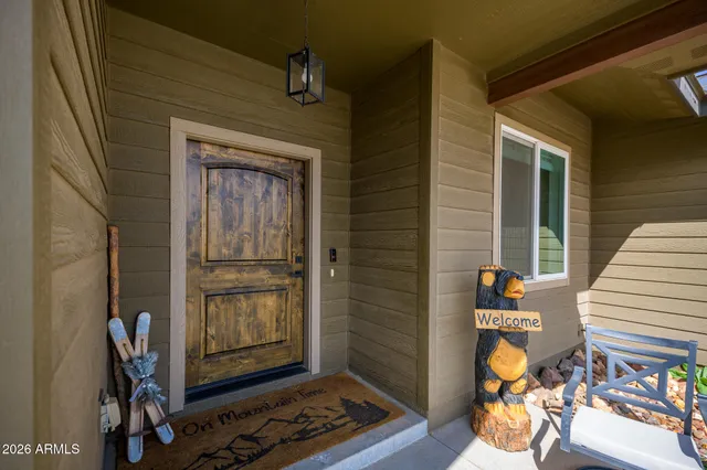 a view of a big house with a big yard and large tree