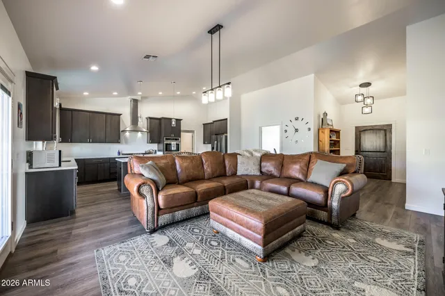 a view of a living room kitchen and a wooden floor