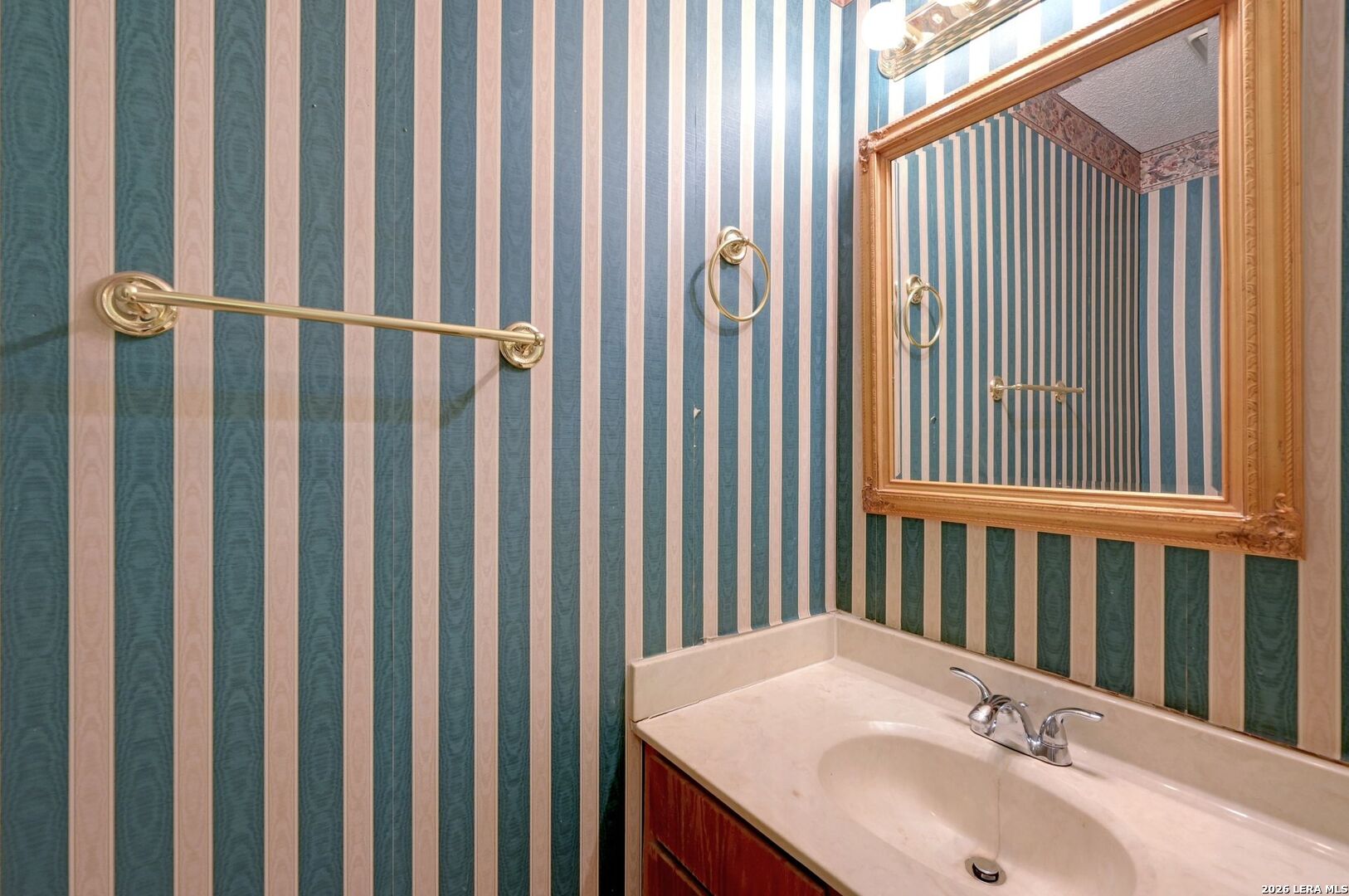 11815 Vance Jackson Road, Unit 1402 San Antonio, TX 78230 - Photo 12 of 29 a bathroom with a sink and a mirror