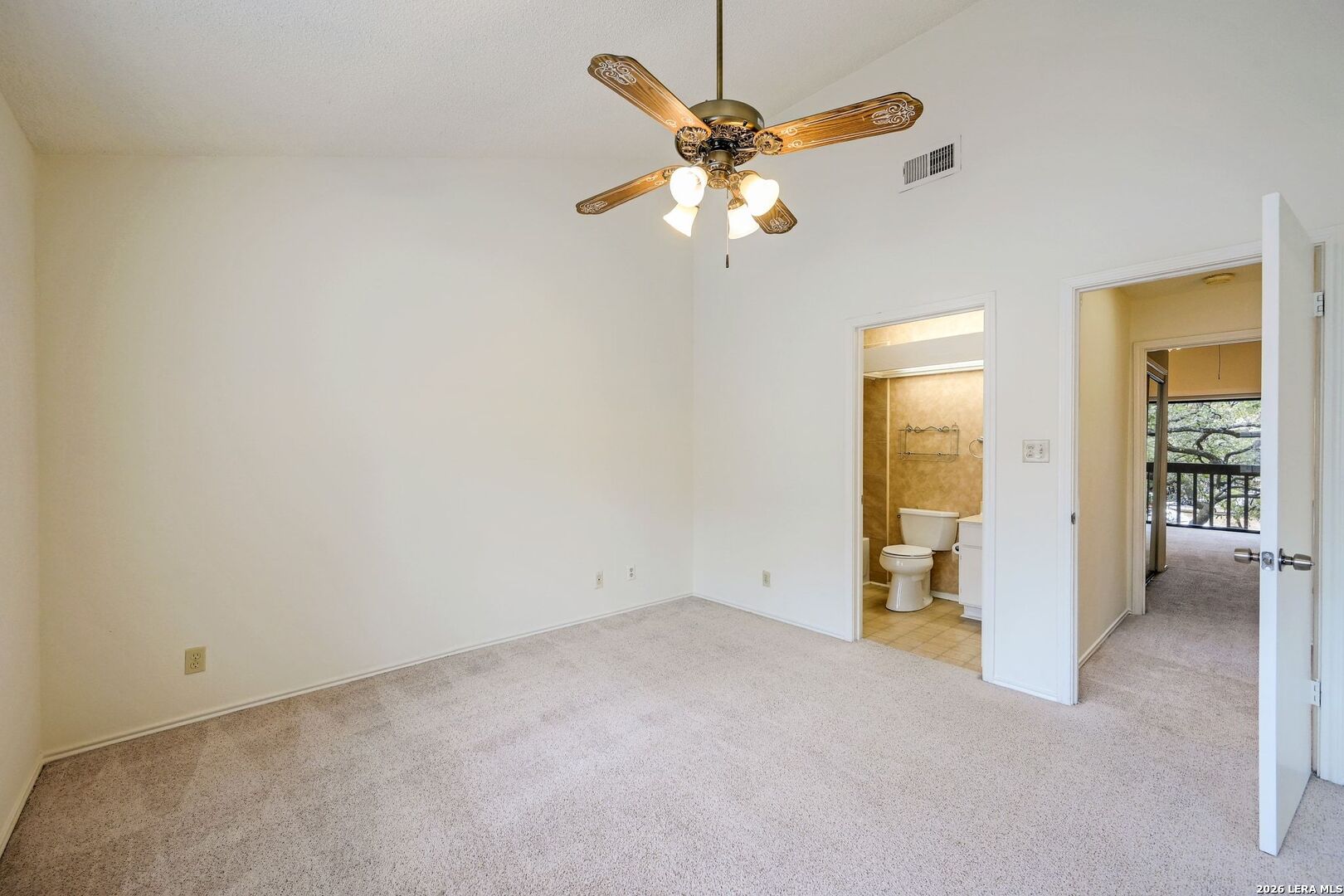 11815 Vance Jackson Road, Unit 1402 San Antonio, TX 78230 - Photo 17 of 29 an empty room with a chandelier fan and a window