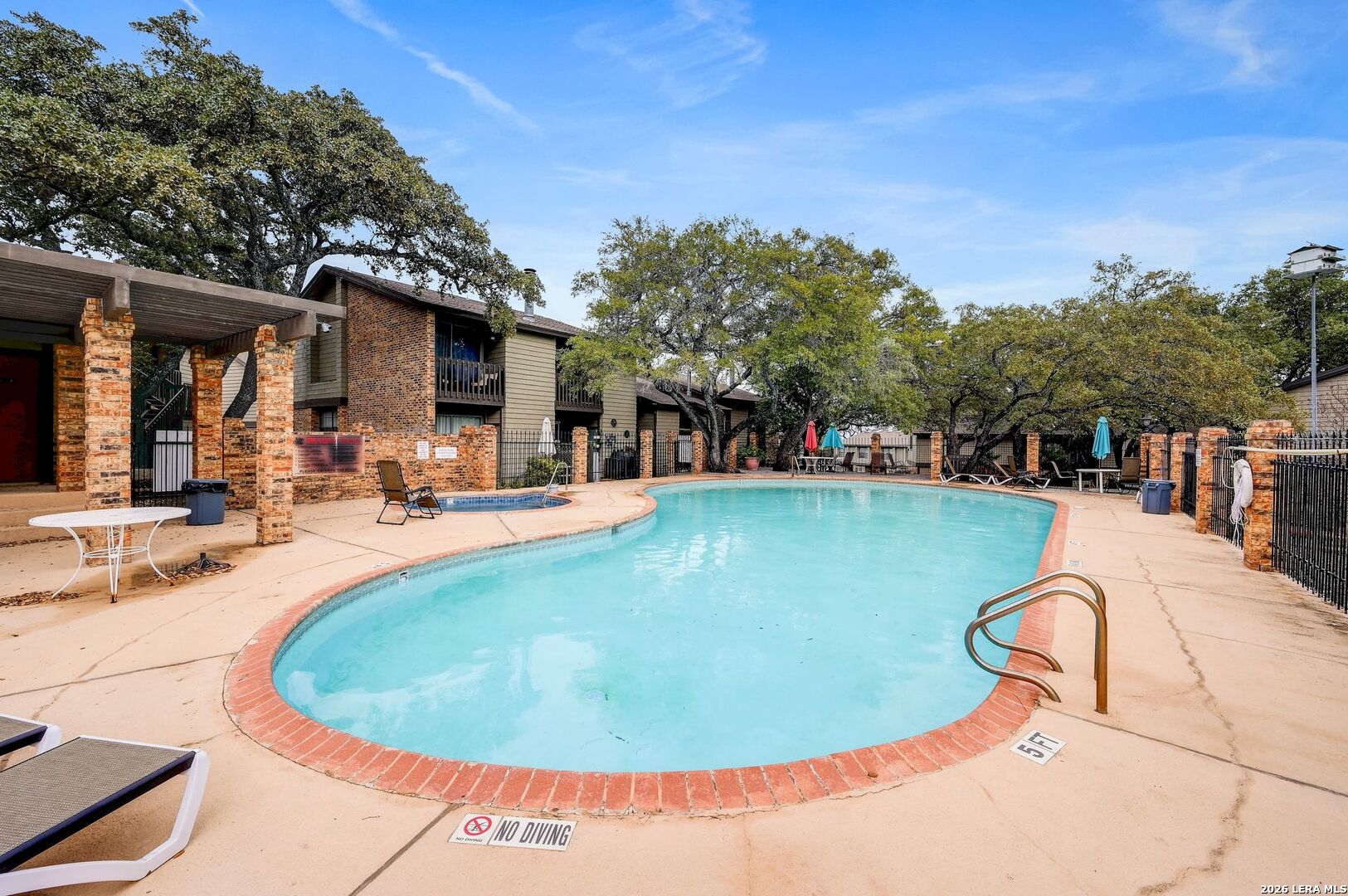 11815 Vance Jackson Road, Unit 1402 San Antonio, TX 78230 - Photo 24 of 29 a view of a swimming pool with a patio