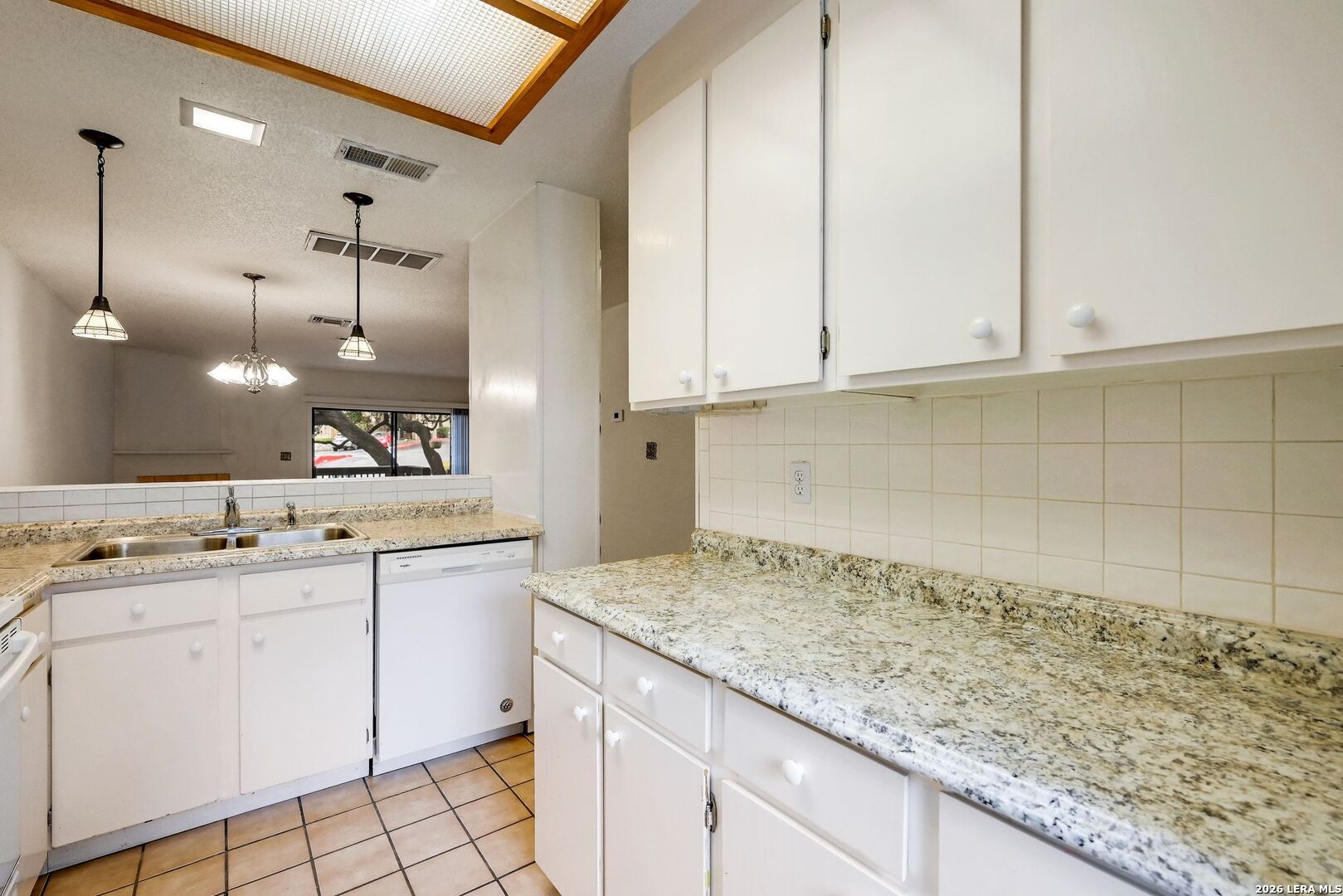 11815 Vance Jackson Road, Unit 1402 San Antonio, TX 78230 - Photo 4 of 29 a kitchen with sink cabinets and a wooden floor