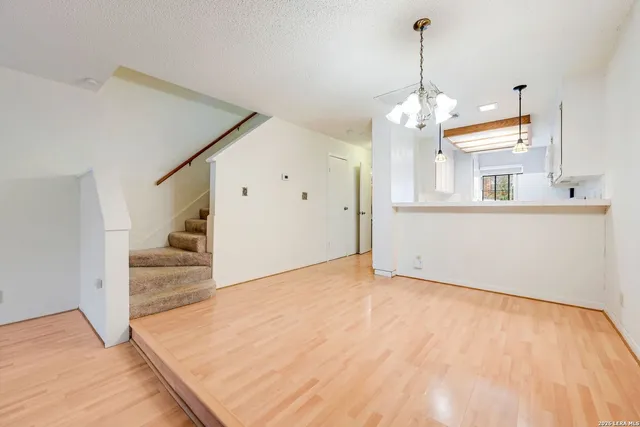 a view of a kitchen with wooden floor and a sink