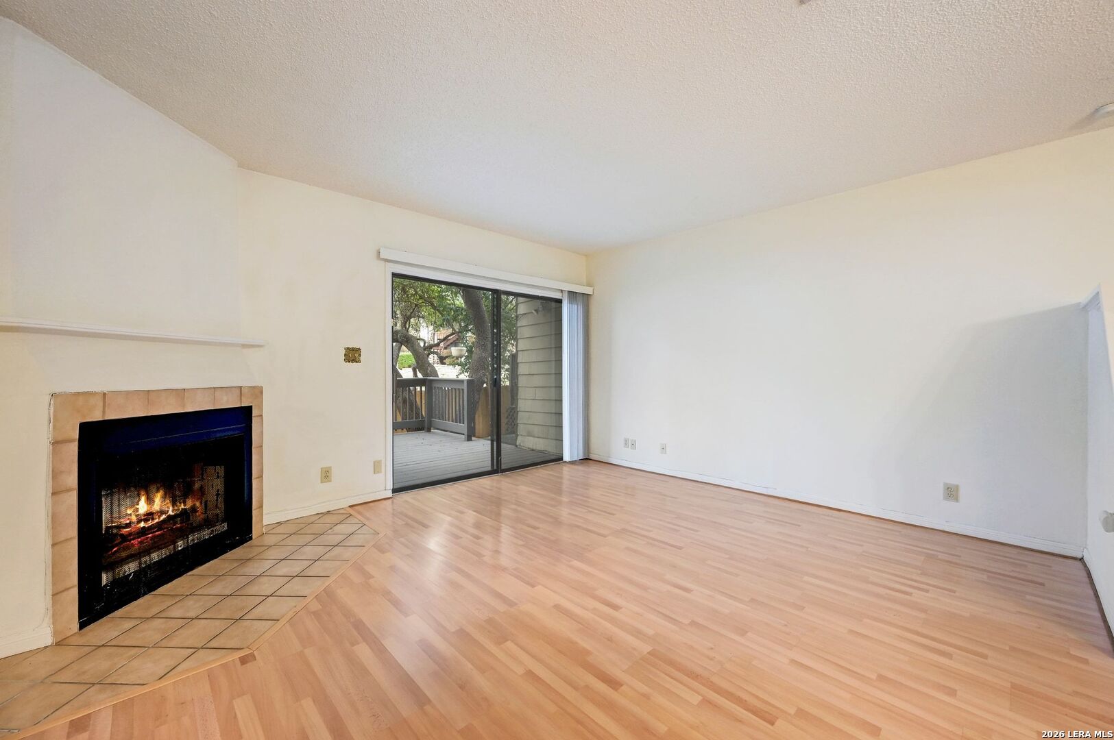 11815 Vance Jackson Road, Unit 1402 San Antonio, TX 78230 - Photo 8 of 29 a view of an empty room with fire place and a fireplace