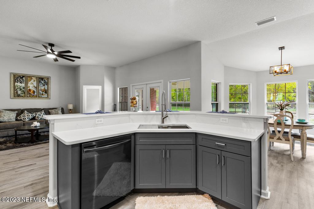 54150 Deerfield Country Club Road Callahan, FL 32011 - Photo 17 of 37 a kitchen with a stove a sink and a refrigerator