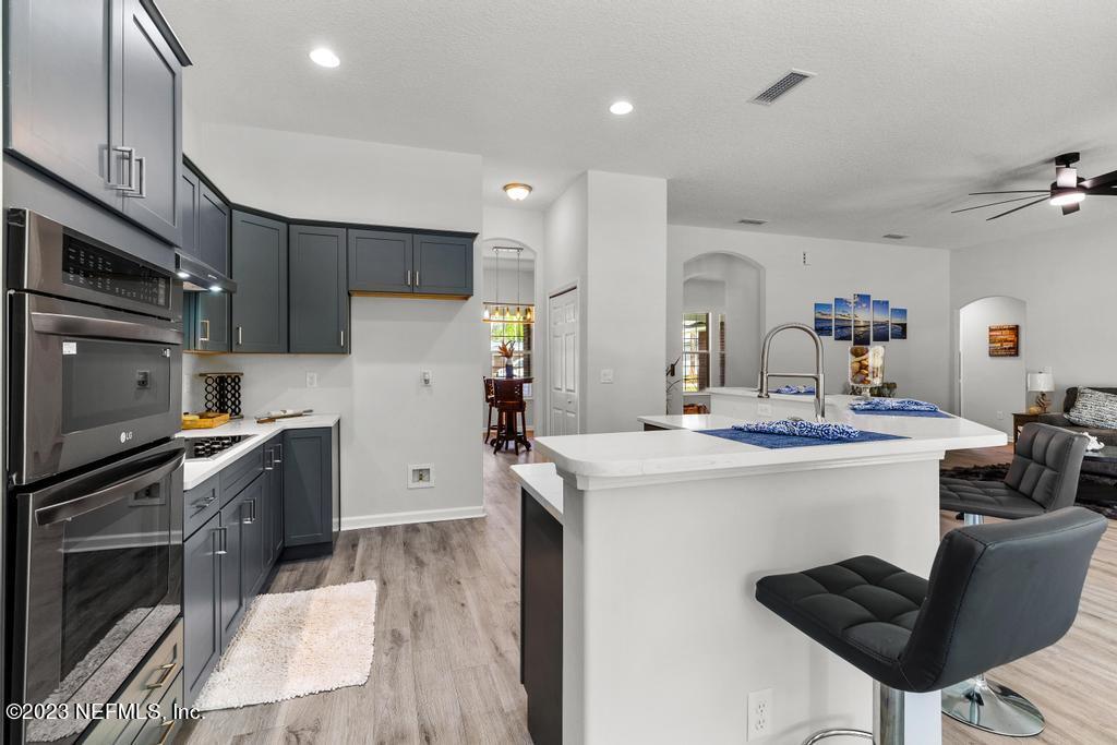 54150 Deerfield Country Club Road Callahan, FL 32011 - Photo 18 of 37 a kitchen with a sink stainless steel appliances and cabinets