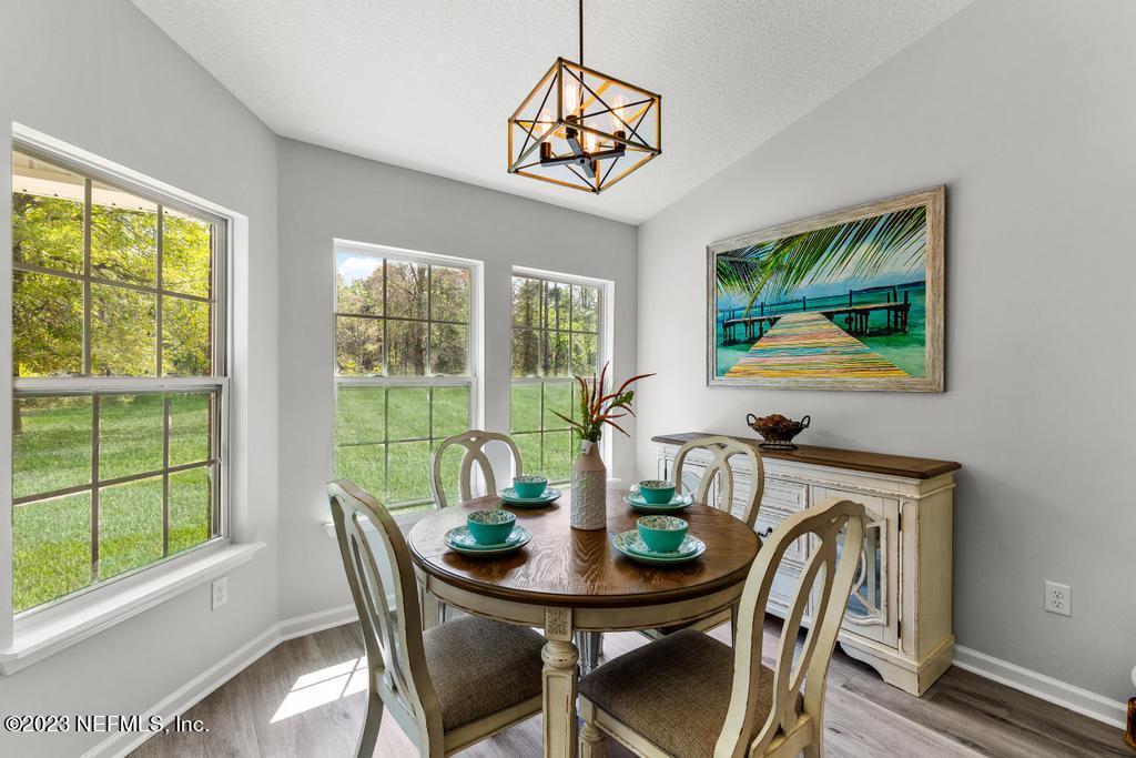 54150 Deerfield Country Club Road Callahan, FL 32011 - Photo 19 of 37 a view of a dining room with furniture window and outside view