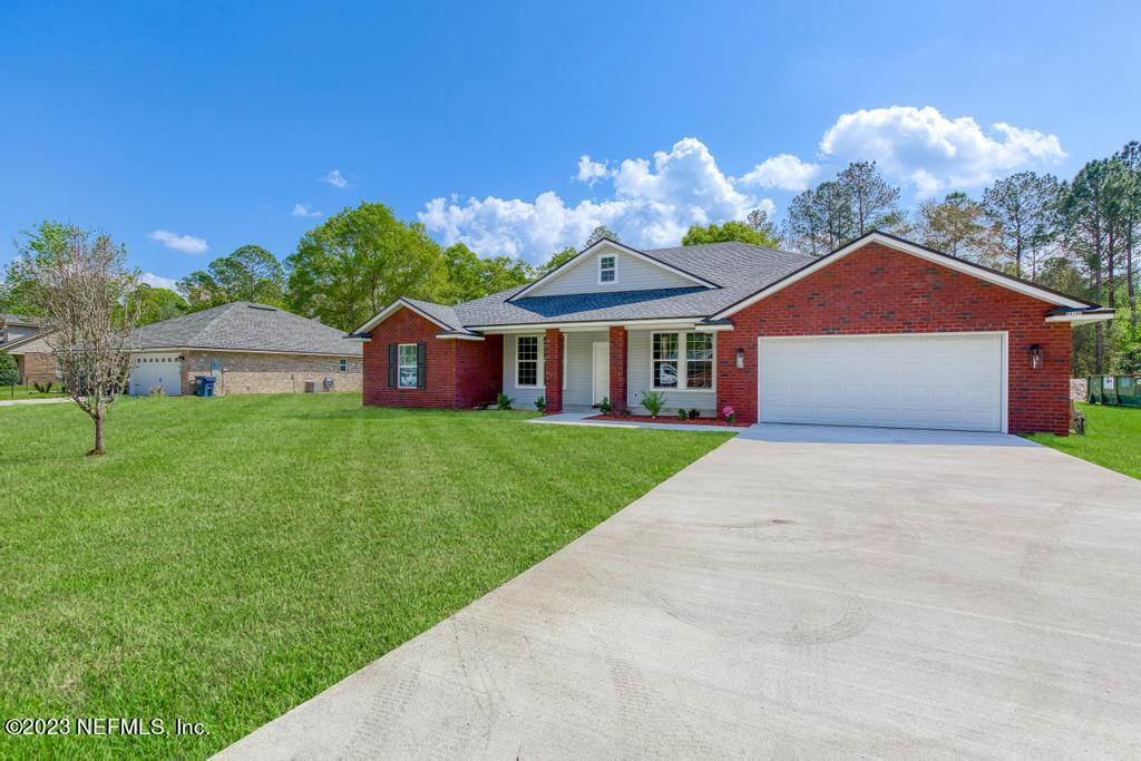 54150 Deerfield Country Club Road Callahan, FL 32011 - Photo 3 of 37 a front view of a house with garden
