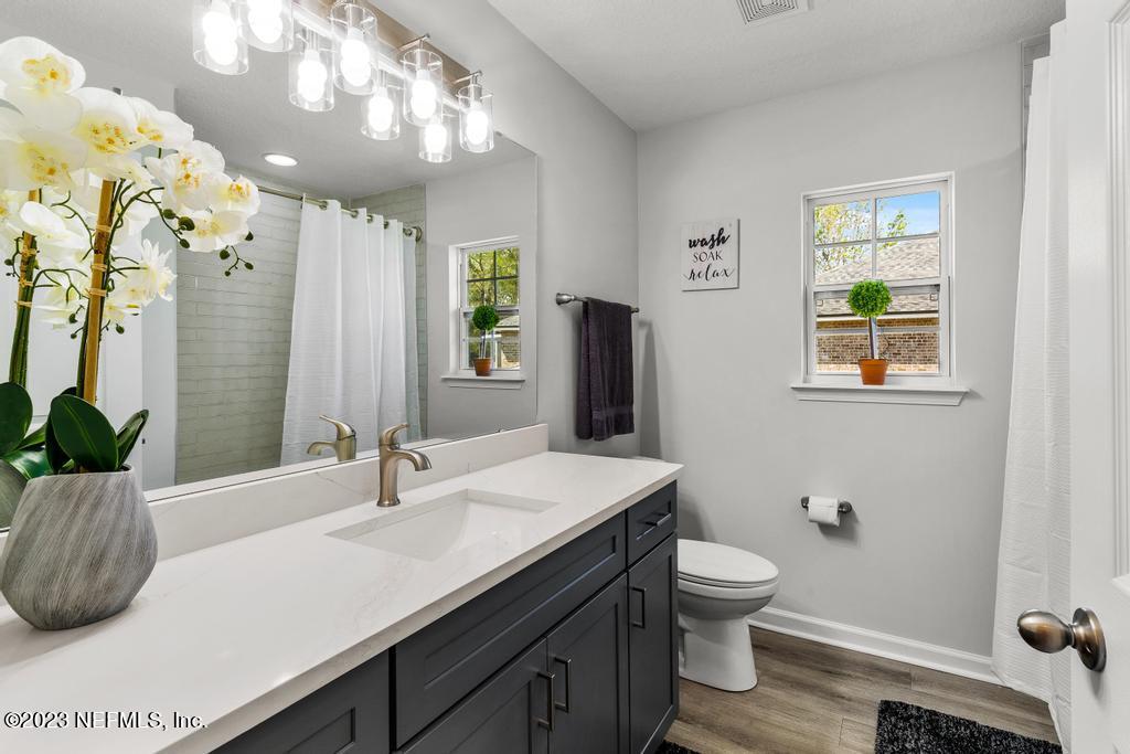 54150 Deerfield Country Club Road Callahan, FL 32011 - Photo 34 of 37 a bathroom with a sink a toilet and mirror
