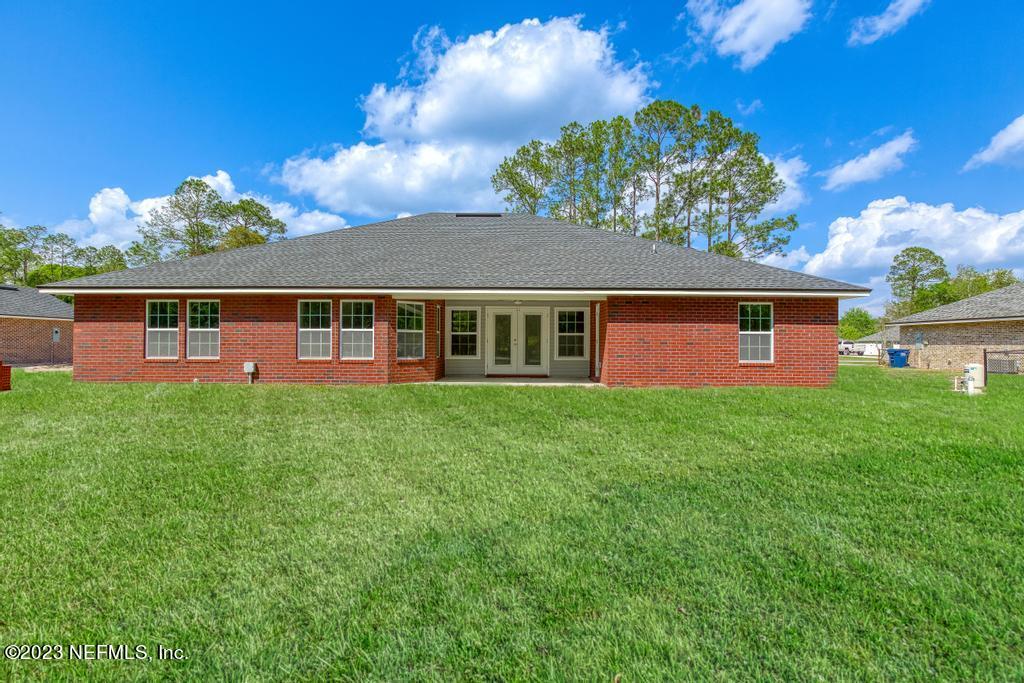 54150 Deerfield Country Club Road Callahan, FL 32011 - Photo 36 of 37 a front view of a house with a garden