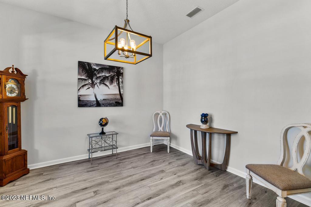 54150 Deerfield Country Club Road Callahan, FL 32011 - Photo 7 of 37 a view of a workspace with furniture and wooden floor
