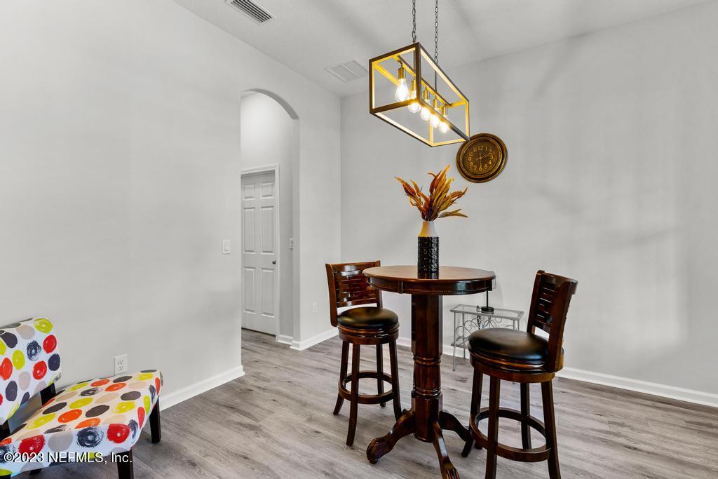 54150 Deerfield Country Club Road Callahan, FL 32011 - Photo 8 of 37 a view of a dining room with furniture and wooden floor