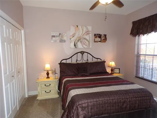 a bed sitting in a bedroom next to a lamp