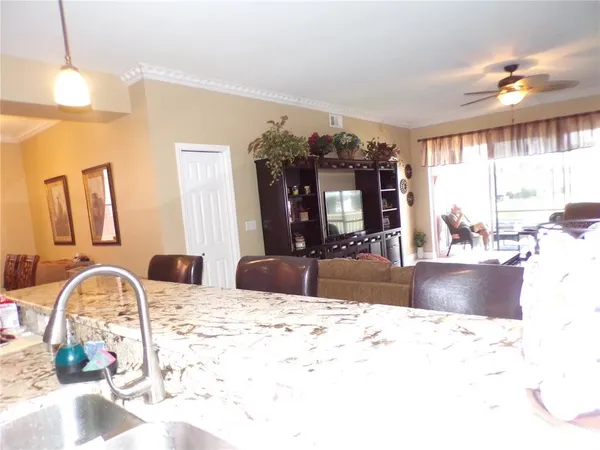a kitchen with stainless steel appliances kitchen island granite countertop a refrigerator and a stove top oven