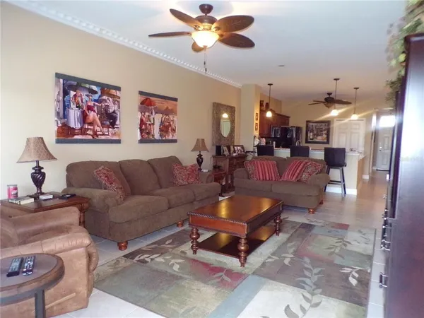 a living room with furniture and a chandelier