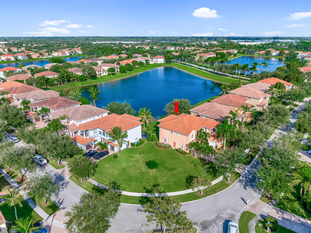 an aerial view of a house with a garden and lake view