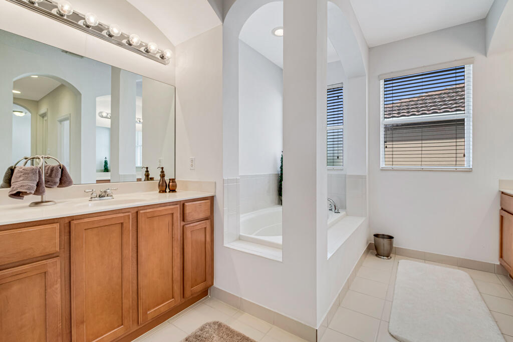 514 Cresta Circle West Palm Beach, FL 33413 - Photo 28 of 74 a bathroom with a tub sink and mirror