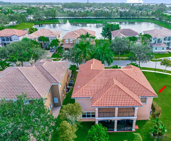 an aerial view of a house with outdoor space and lake view