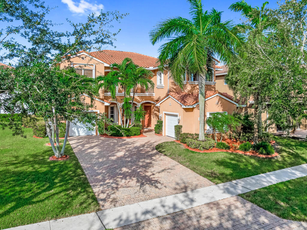 514 Cresta Circle West Palm Beach, FL 33413 - Photo 6 of 74 a front view of a house with a yard and potted plants